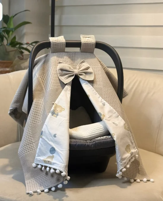 Waffle cotton baby car seat canopy with printed poplin lining, bow detail, and pom pom trim on an infant car seat- beige-baby-car-seat-cover-wf05